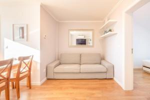 a living room with a couch and a table at GuestReady - Sunny spacious in Belém in Lisbon