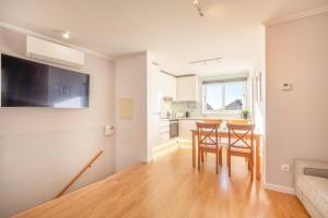 a kitchen and dining room with a table and chairs at GuestReady - Sunny spacious in Belém in Lisbon +18 photos