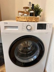 a washing machine with a basket on top of it at Appartement T2 La Belle Epoque in Morteau +5 photos