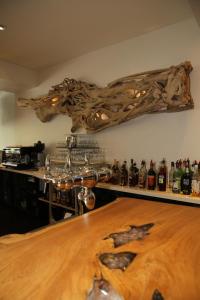 a room with a wooden table and bottles of alcohol at Hôtel Campo Dell'oro in Ajaccio