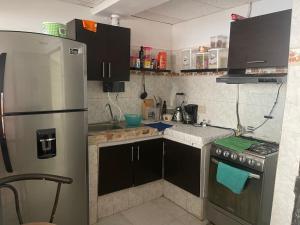 a kitchen with a stainless steel refrigerator and a stove at La plata huila in La Plata