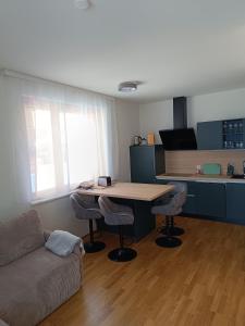 a living room with a table and a couch at Nassfeldpass Pistenblick in Sonnenalpe Nassfeld