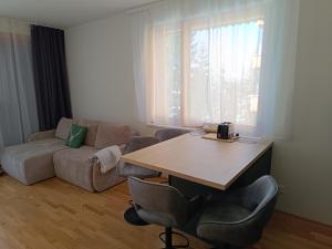 a living room with a table and a couch at Nassfeldpass Pistenblick in Sonnenalpe Nassfeld
