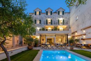 an estate with a swimming pool in front of a building at NEW - Casa Columba - 4 Star Design Boutique Hotel with Outdoor Pool & Private Garden in Makarska