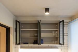 a glass cabinet in a room with dishes on it at Loft Marília City in Marília +20 photos