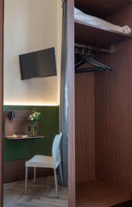 a room with a bed and a table and a chair at Hotel Casa Del Pellegrino in Padova