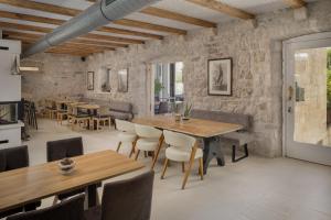 a dining room with wooden tables and chairs at NEW - Casa Columba - 4 Star Design Boutique Hotel with Outdoor Pool & Private Garden in Makarska