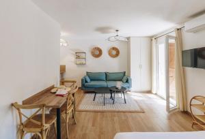 a living room with a blue couch and a table at Oro Biancu in Lucciana