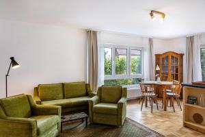 a living room with a couch and chairs and a table at Grashüpfer Plus bis 6 Pers in Freiensteinau
