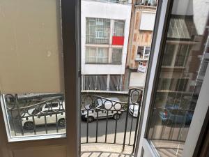 a view from a window of a street with cars at Chambre musicale in Brussels
