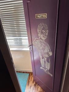 a purple door with a picture of a boy on it at Chambre musicale in Brussels