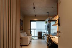a living room with a couch and a table at Loft Marília City in Marília