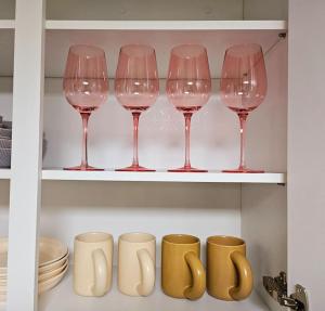 a row of wine glasses on a shelf in a kitchen at Snug J House in Seoul +25 photos