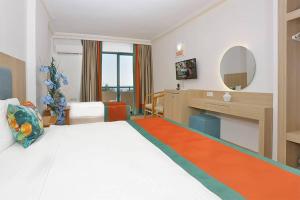a hotel room with a bed and a desk at Club Mirabell hotel in Elikesik +19 photos