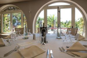 a long table with silverware and napkins on it at Hôtel Campo Dell'oro in Ajaccio