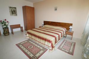 a bedroom with a bed and two rugs on the floor at B&B La Ganzaria in San Michele di Ganzaria +7 photos
