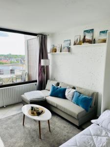 a living room with a couch and a table at Möwenblick in Wendtorf +8 photos