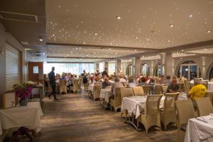 a dining room with people sitting at tables at Hôtel Campo Dell'oro in Ajaccio