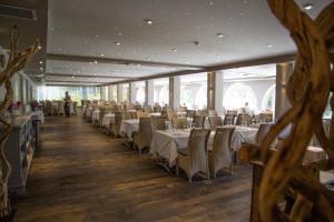 a dining room with white tables and chairs at Hôtel Campo Dell'oro in Ajaccio