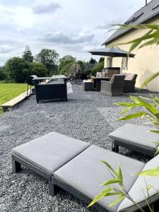 a patio with benches and a grill and a playground at Spacious Luxury countryside retreat in Estry