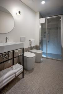 a bathroom with a toilet and a sink and a shower at Hotel Casa Del Pellegrino in Padova