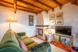 a living room with a couch and a fireplace at GuestReady - Sintra Cosy House in Sintra