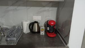 a kitchen counter with a coffee maker and a mixer at Elea House 2 in Keramoti