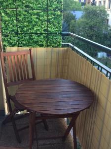 a wooden chair sitting next to a wooden table on a balcony at Studio in Dresden Neustadt balcony and parking in Dresden
