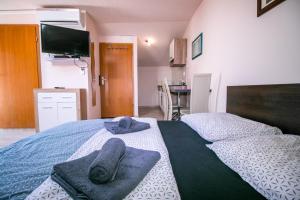 a bedroom with a bed with towels on it at Apartment Jug in Piran +42 photos