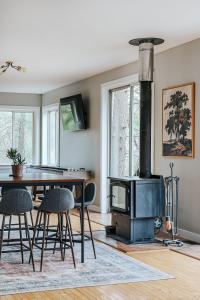 a living room with a fireplace and a table with chairs at Two Forest Cabins,Decks,Fire Pit,Hot Tubs,GameRoom in Berkeley Springs