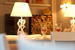 a table with two lamps and two glasses on it at Pension Vitalis in Willingen