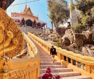 a person walking up a set of stairs in a temple at Hương Tràm Homestay in Hồ Ðá