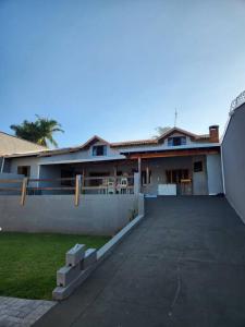 a large house with a driveway in front of it at Casa grande com piscina Chácara do Dinho in Londrina