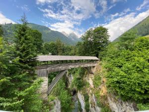a bridge over a river in the mountains at Apart TYROL in Finkenberg