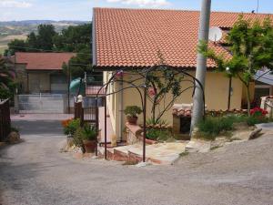 a house with a gate with potted plants on it at B&B La Ganzaria in San Michele di Ganzaria