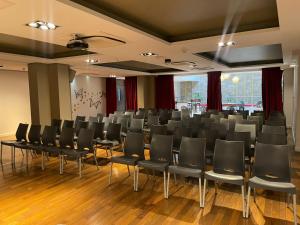a conference room with black chairs and a large window at Kenton Palace Buenos Aires in Buenos Aires