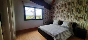 a small bedroom with a bed and a window at Appartement spacieux à Saint-Pierre-du-Mont 200 m² avec jardin in Saint-Pierre-du-Mont