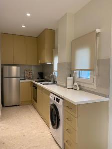 a kitchen with a washer and a dishwasher at 3rd Floor A MicroApartment in Kavala +6 photos