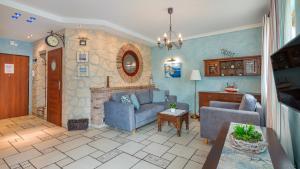 a living room with two couches and a fireplace at Willa Jazgór, Sun & Snow in Jastrzębia Góra