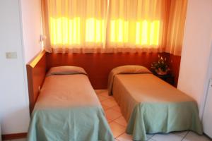 Postel nebo postele na pokoji v ubytování Hotel Excelsior
