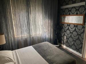 a bedroom with a bed and a window at Chambre année 70 in Brussels
