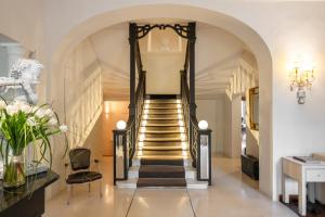 a hallway with a spiral staircase with a stair railing at Hotel Vannucci in Citt&agrave; della Pieve