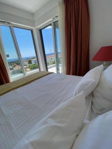a bedroom with a bed with a view of the ocean at 4Star Seaview Penthouse Krk in Krk