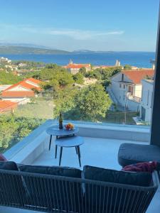 a balcony with a table and a view of the ocean at 4Star Seaview Penthouse Krk in Krk
