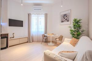 a living room with a white couch and a table at Little Bangkok - Luxury SPA Apartment in Toulon
