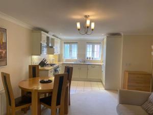 a kitchen and dining room with a table and chairs at Haven With Patio in Basingstoke