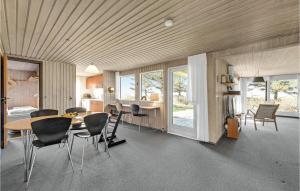 a kitchen and dining room with a table and chairs at 3 Bedroom Gorgeous Home In Thyholm in Thyholm