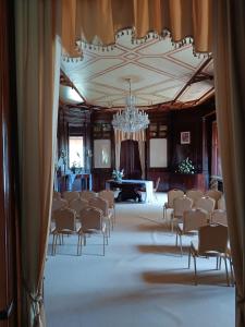 a large room with chairs and a chandelier at Penzion na zámku Bartošovice in Nový Jičín