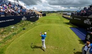 a man swinging a golf club on a golf course at Dunluce Park 1 - Dog friendly - Portrush by the Sea in Portrush