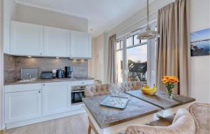 a kitchen and dining room with a table and chairs at Baltischer Hof Apartment 66 in Boltenhagen
